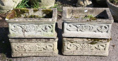 Four rectangular reconstituted stone troughs, moulded with flowerheads and scrolls,