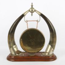 Edwardian brass and horn dinner gong, on a stepped base, 50cm high
