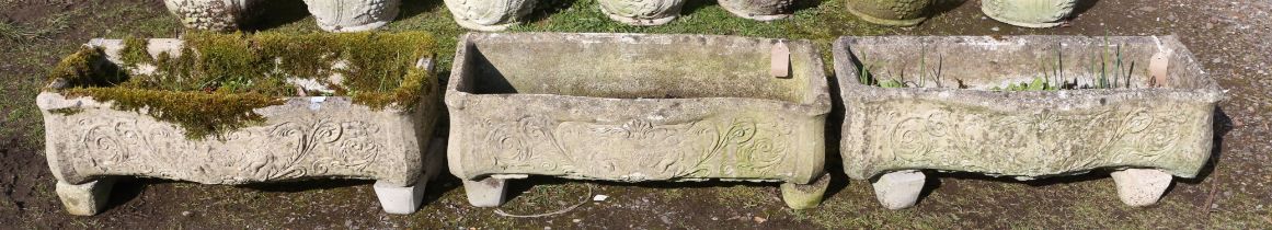 Three rectangular reconstituted stone troughs, with serpentine front, moulded with cherubs and