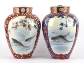 An associated pair of Fukagawa Imari vases; each one decorated with typical panels of swimming carp