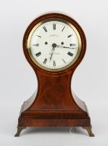 A Late 19th century mahogany and line inlaid mantel clock of balloon shape. The white enamelled