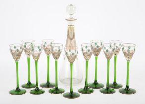 A Bohemian glass decanter and eleven matching glasses, C.1900, hand painted with stylised flowers.