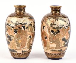 A pair of blue-ground Satsuma vases; each one decorated in typical colours and gilt with panels of