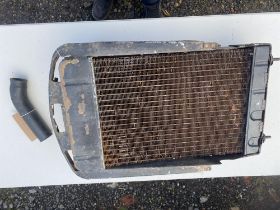 Morris 8 radiator in scruffy condition but no leaks including top hose. Cap is missing from the