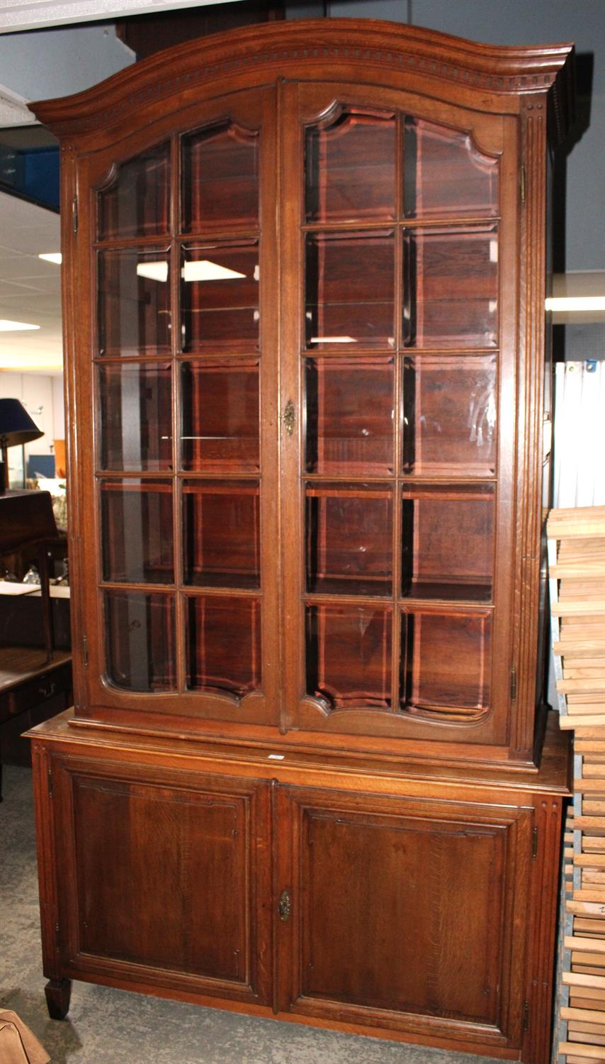 A French Louis XVI style oak display cabinet cupboard, early 20th century, in two parts,