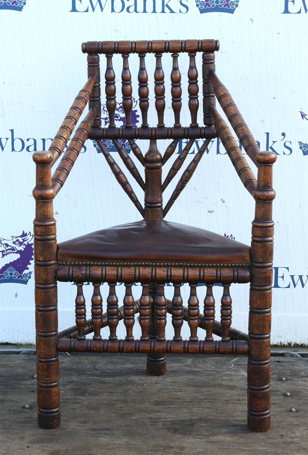 An Edwardian oak turner's chair,1900s, bobbin and ring turned, with later leather inset seat,