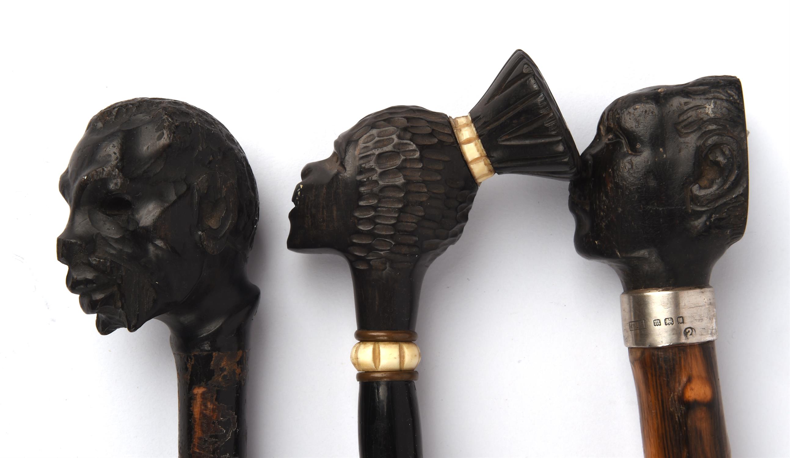 A hardwood parasol, 20th Century, with a finial carved in the form of an African native lady, - Image 2 of 2