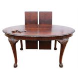 A George III style mahogany extending dining table, 1920s/30s, top quarter veneered in flame