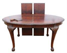 A George III style mahogany extending dining table, 1920s/30s, top quarter veneered in flame