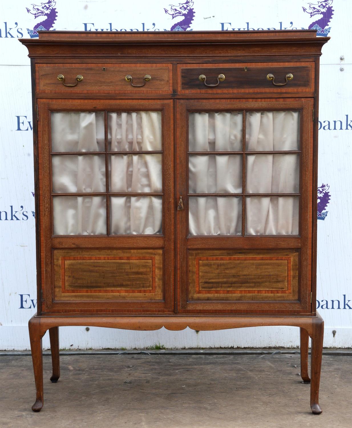 An Edwardian mahogany and satinwood banded cabinet, the interior with three adjustable shelves,