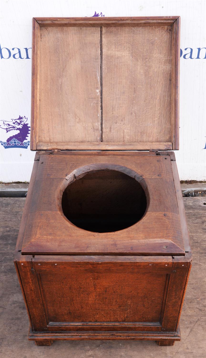 A George III oak box seat commode, of panelled form, the hinged lid revealing a removable seat, - Image 2 of 2