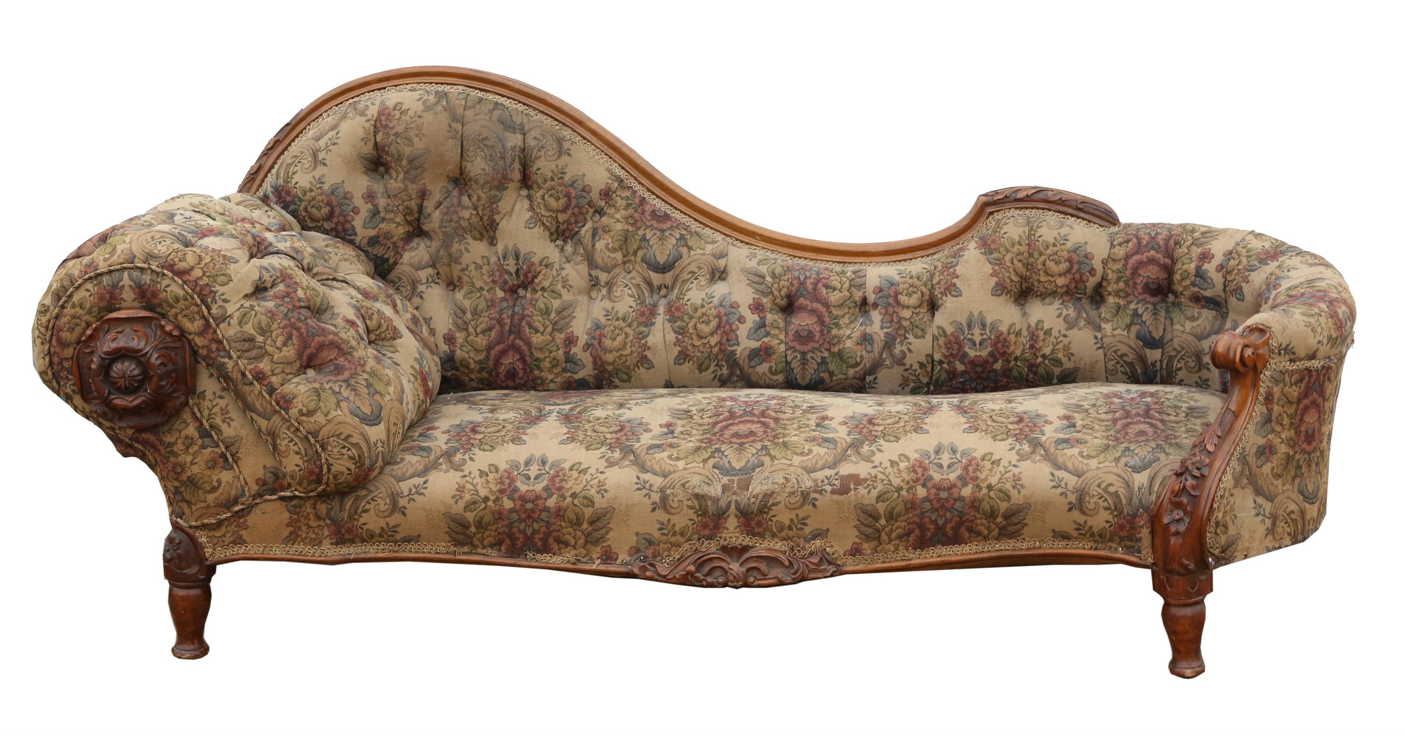 A Victorian walnut and upholstered chaise longue, the arm with a large leaf carved roundel, L 208cm