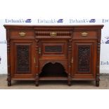 A late Victorian walnut sideboard, of breakfront form, doors scroll and anthemion carved,