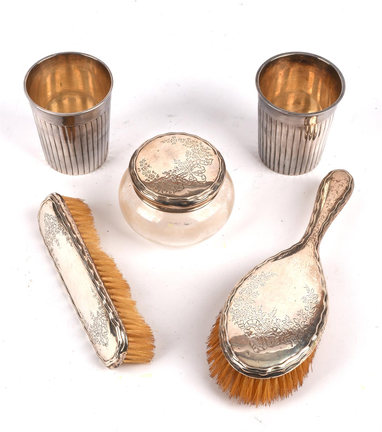 Two silver backed brushes, a large silver capped jar and two white metal beakers