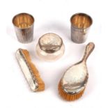 Two silver backed brushes, a large silver capped jar and two white metal beakers
