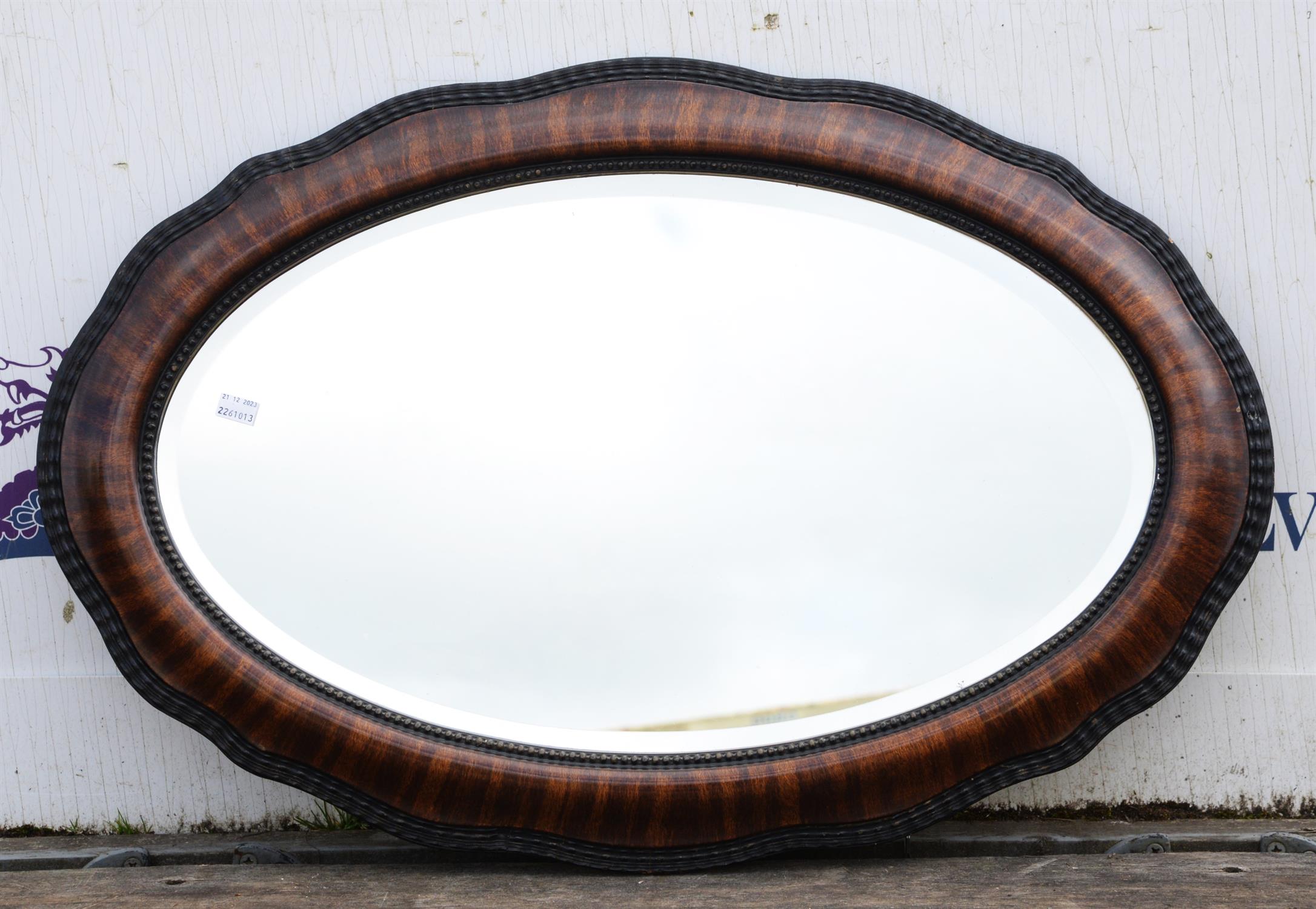 Oval mahogany mirror, 20th Century, with ripple edge moulding, 56 x 84cm