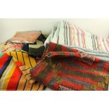 A box of various throws and bedcovers, 20th century, to include a patchwork throw,