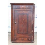 An 18th century Oak corner cupboard, single door over single drawer flanked by faux drawers.