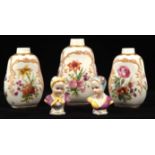 Set of three graduated porcelain vases, 19th Century, probably tea caddies lacking lids,