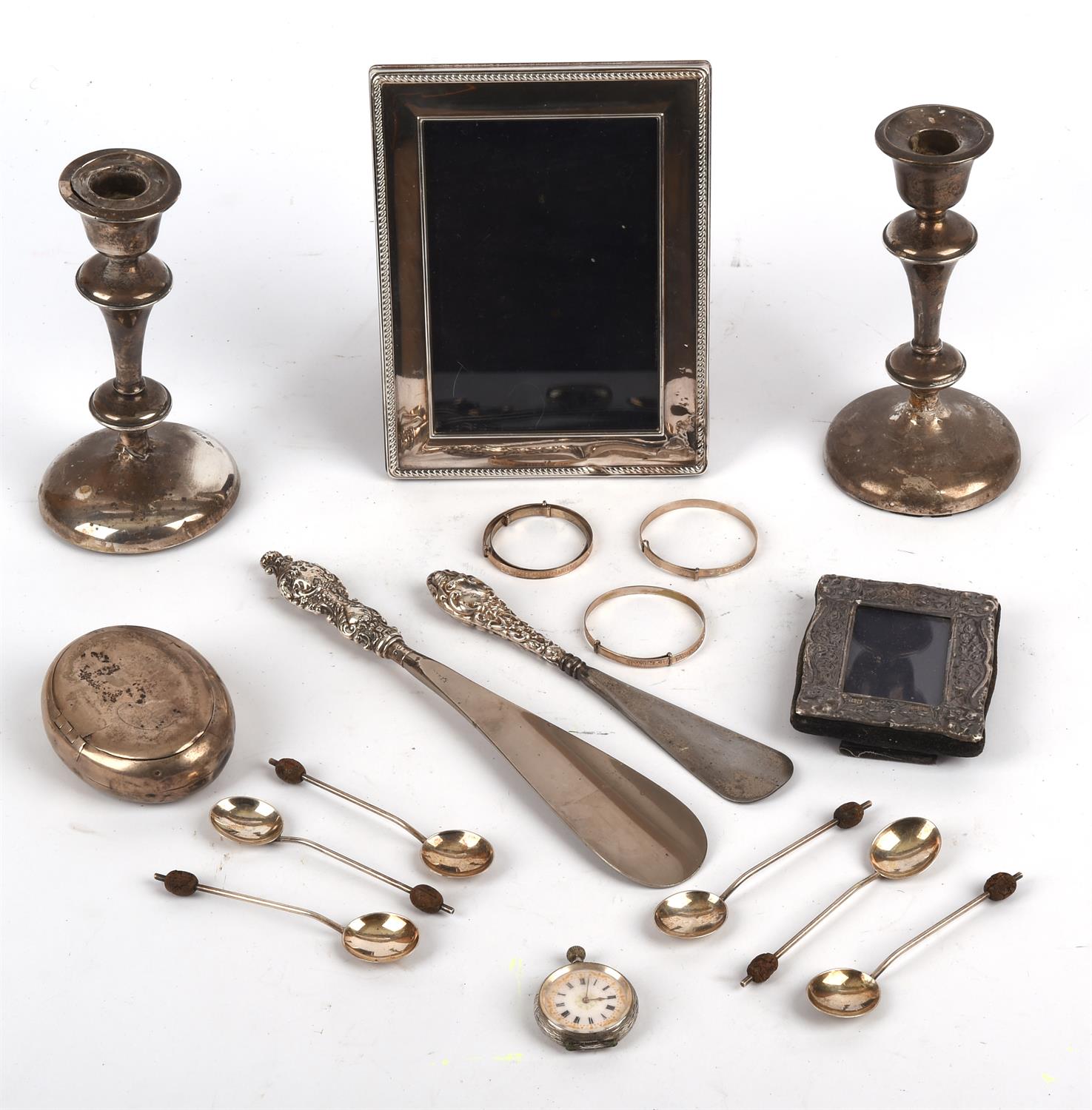 Quantity of mixed silver to include a pair of candlesticks, photo frames, tobacco squeeze box,