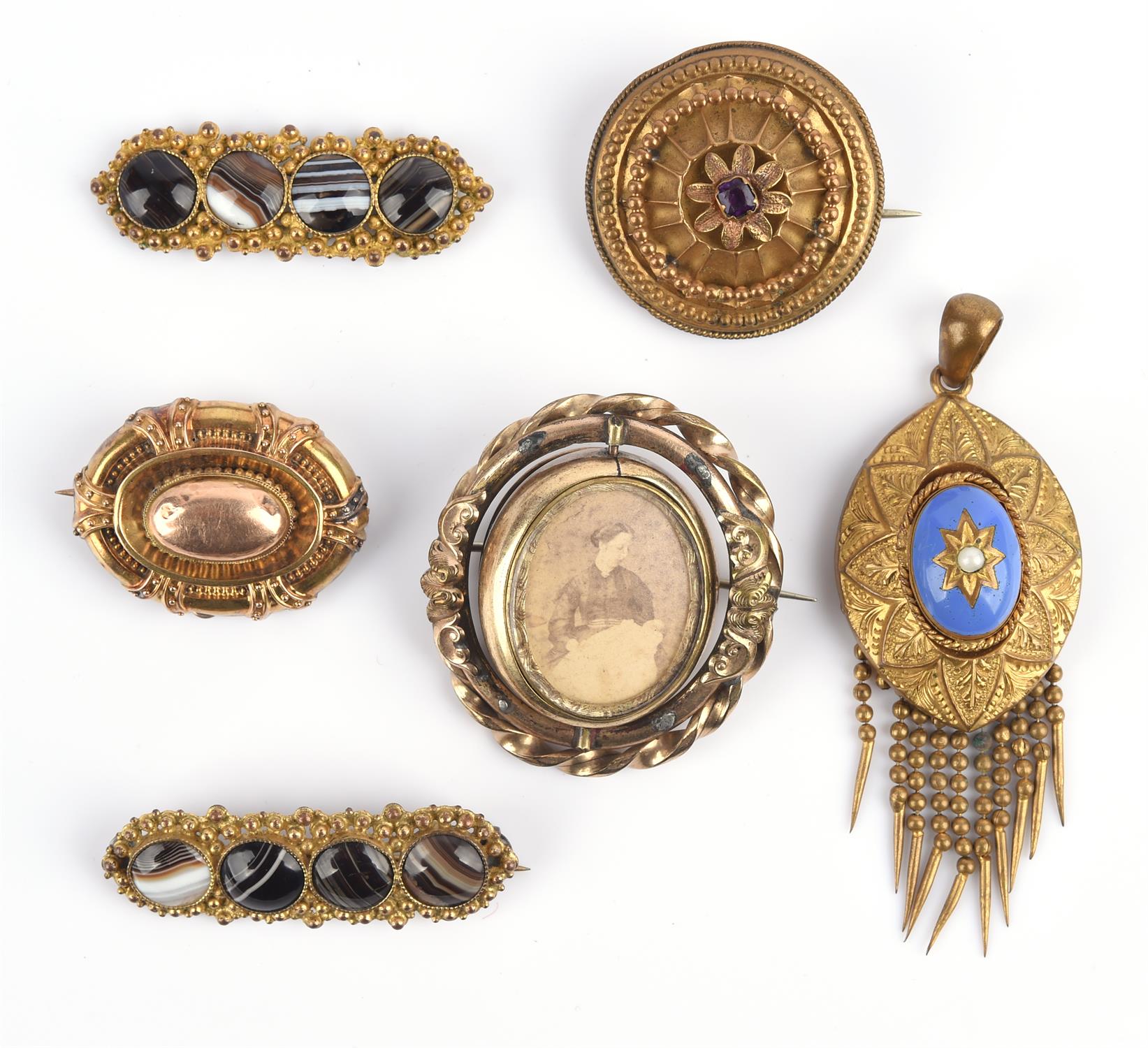 Six Victorian brooches, five in gilt metal including one swivel brooch with a cameo to one side and