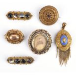 Six Victorian brooches, five in gilt metal including one swivel brooch with a cameo to one side and
