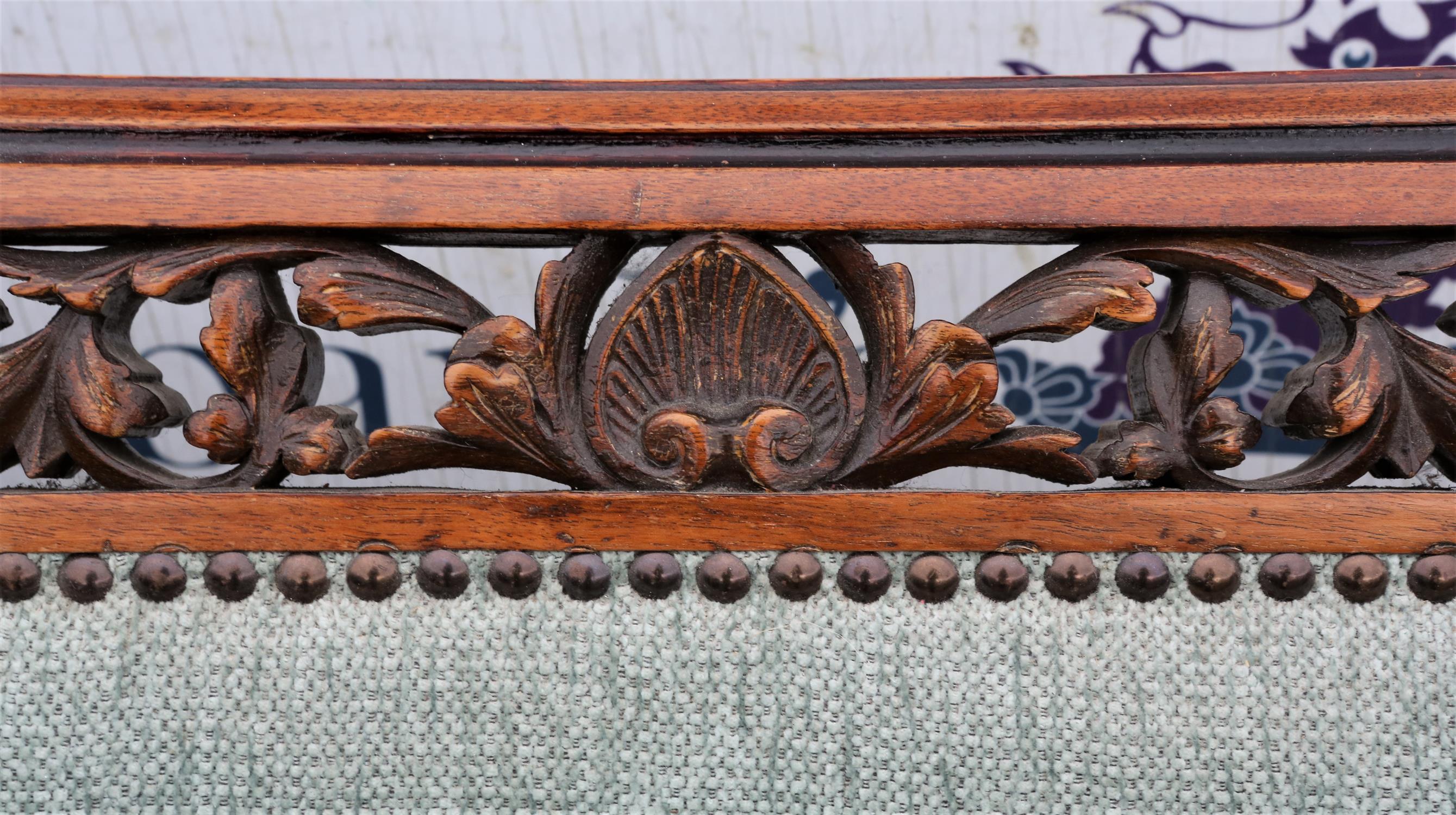 A late Victorian walnut and upholstered settee, the top rail pierced and leaf carved, - Image 5 of 6