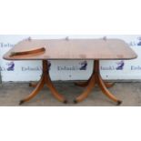 A Regency mahogany twin pillar dining table, the column supports with quadruple sabre legs and