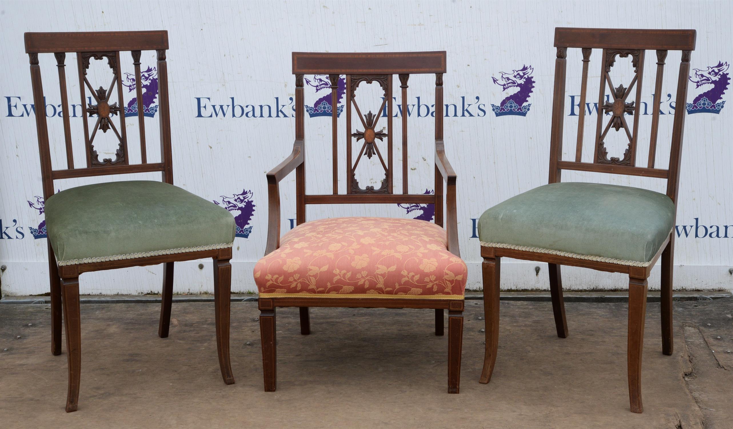 A pair of Edwardian mahogany and crossbanded salon chairs, together with an en suite armchair,