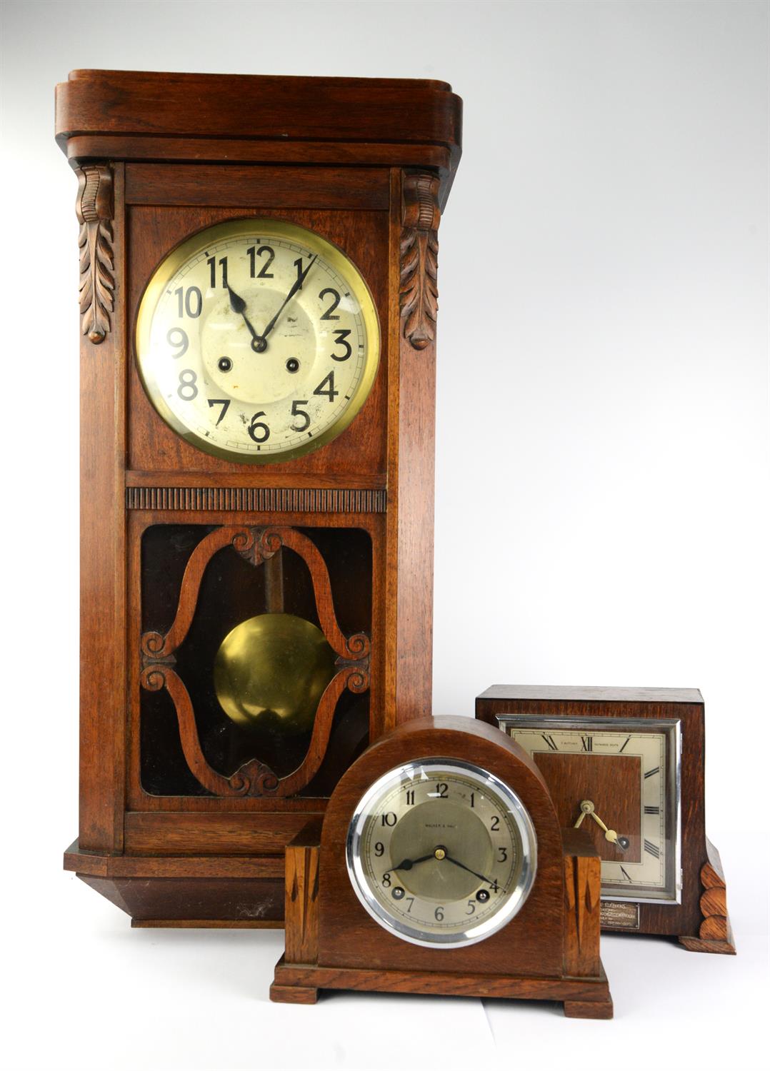 An oak cased two train wall clock. early 20th century, with silvered dial, Arabic numerals brass