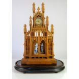 An early 20th century oak fretwork carved clock in the form of a Cathedral. The central recess