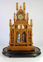 An early 20th century oak fretwork carved clock in the form of a Cathedral. The central recess