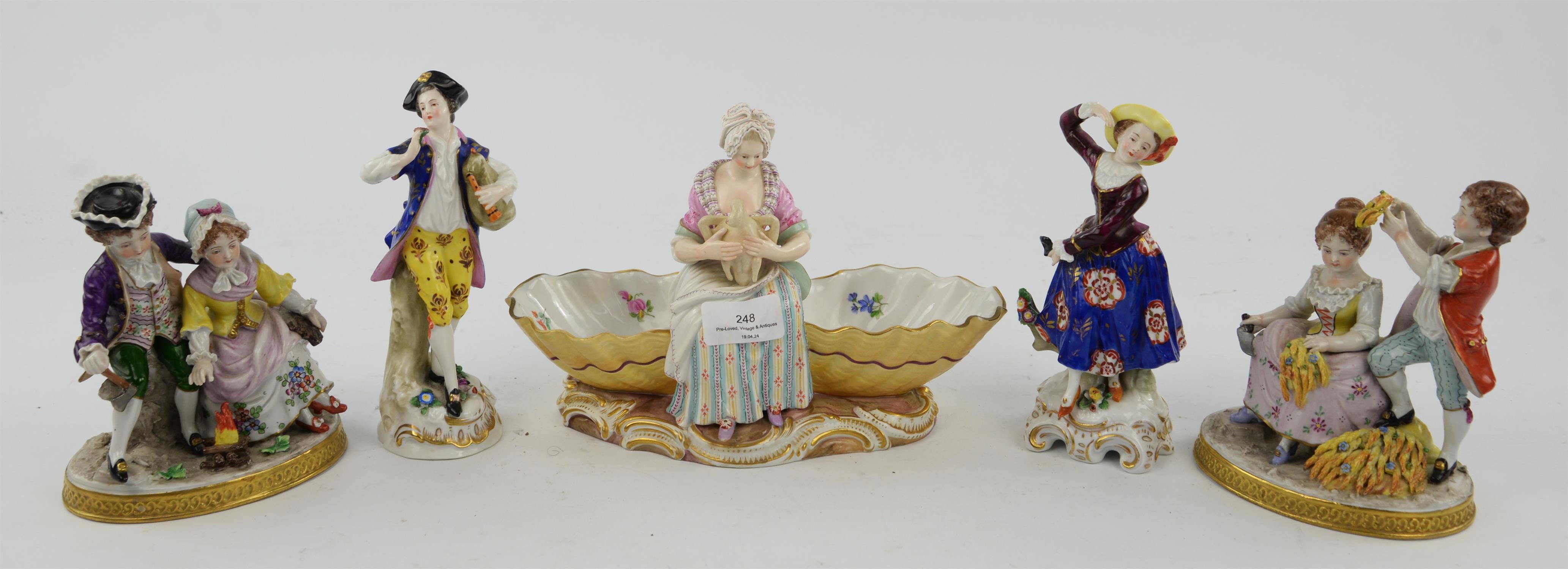 A Meissen porcelain salt cellar, modelled as woman holding a swan and flanked by a pair of floral