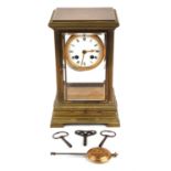 A French early 20th century brass mantel clock, with a 8in white enamel dial with Roman numerals,