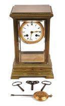 A French early 20th century brass mantel clock, with a 8in white enamel dial with Roman numerals,