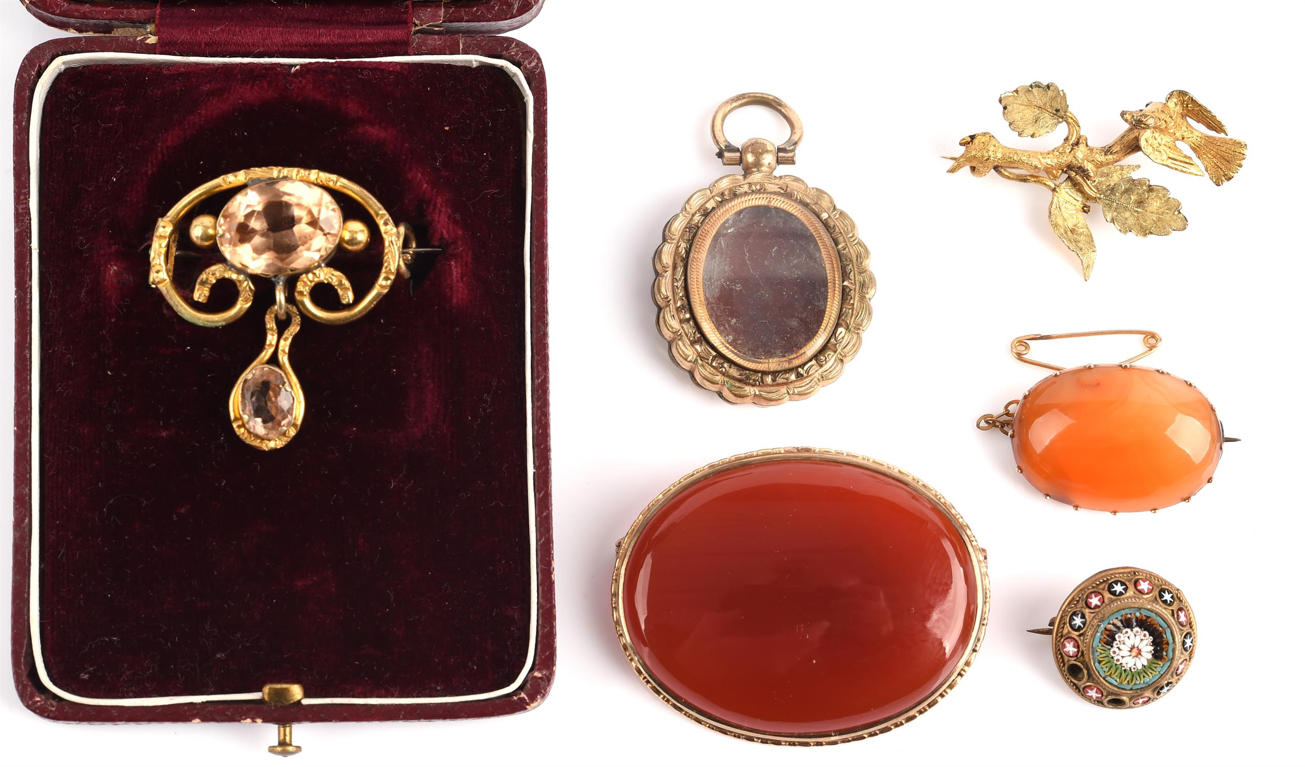 A collection of mainly brooches including a gold plated topaz brooch, two carnelian brooches in 9