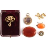 A collection of mainly brooches including a gold plated topaz brooch, two carnelian brooches in 9