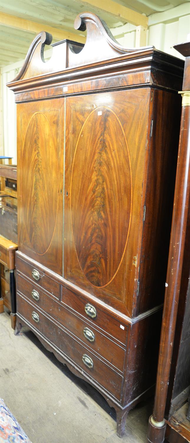 A Victorian mahogany linen press with broken arch pediment. Height 219 cm, width 128cm.