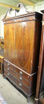 A Victorian mahogany linen press with broken arch pediment. Height 219 cm, width 128cm.