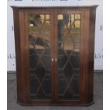 Mahogany corner cabinet, 19th Century, with two glazed doors enclosing shelves, H109 x W90.5 x 50D