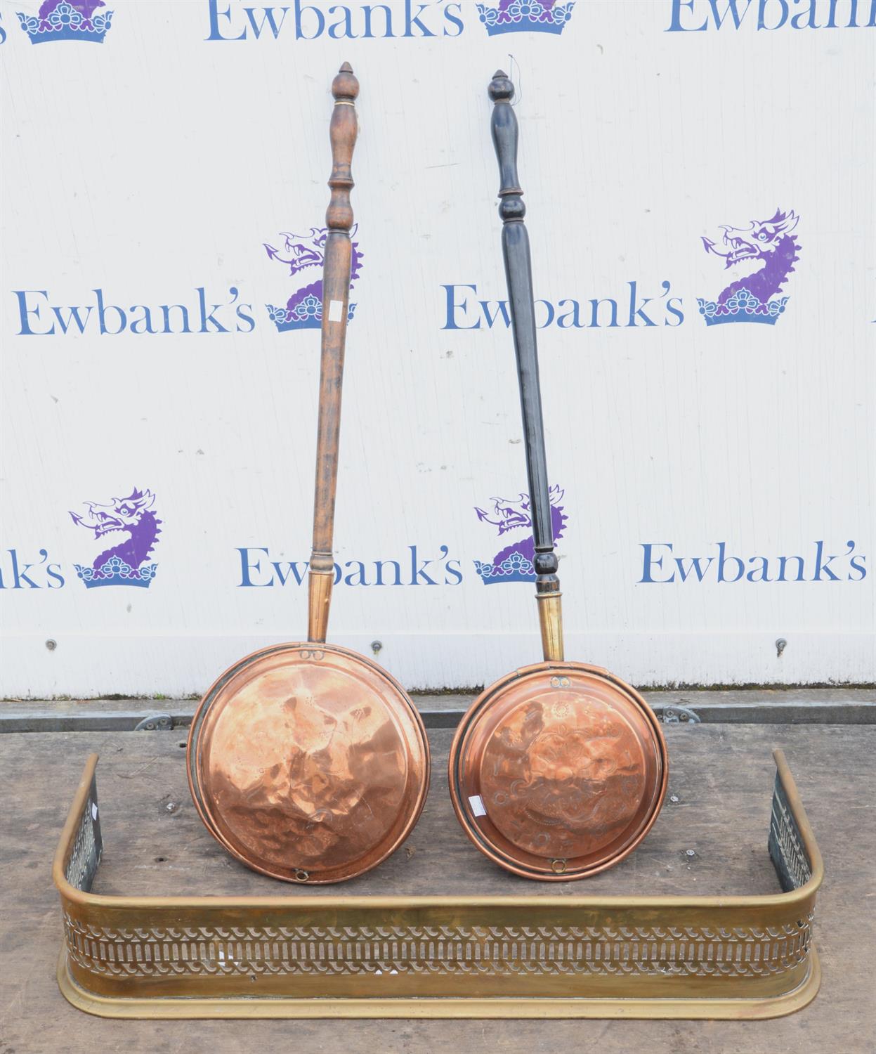 A Victorian pierced brass fender, together with two copper warming pans, fender 89cm long, (3)