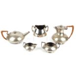 An English Pewter four piece tea and coffee set, planished and with raffia handles,