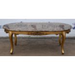 A Louis XVI style giltwood coffee table, mid 20th century, with an oval mottled brown marble top,