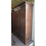 A Victorian mahogany wardrobe, the hinged doors enclosing an arrangement of shelves and drawers