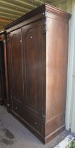 A Victorian mahogany wardrobe, the hinged doors enclosing an arrangement of shelves and drawers