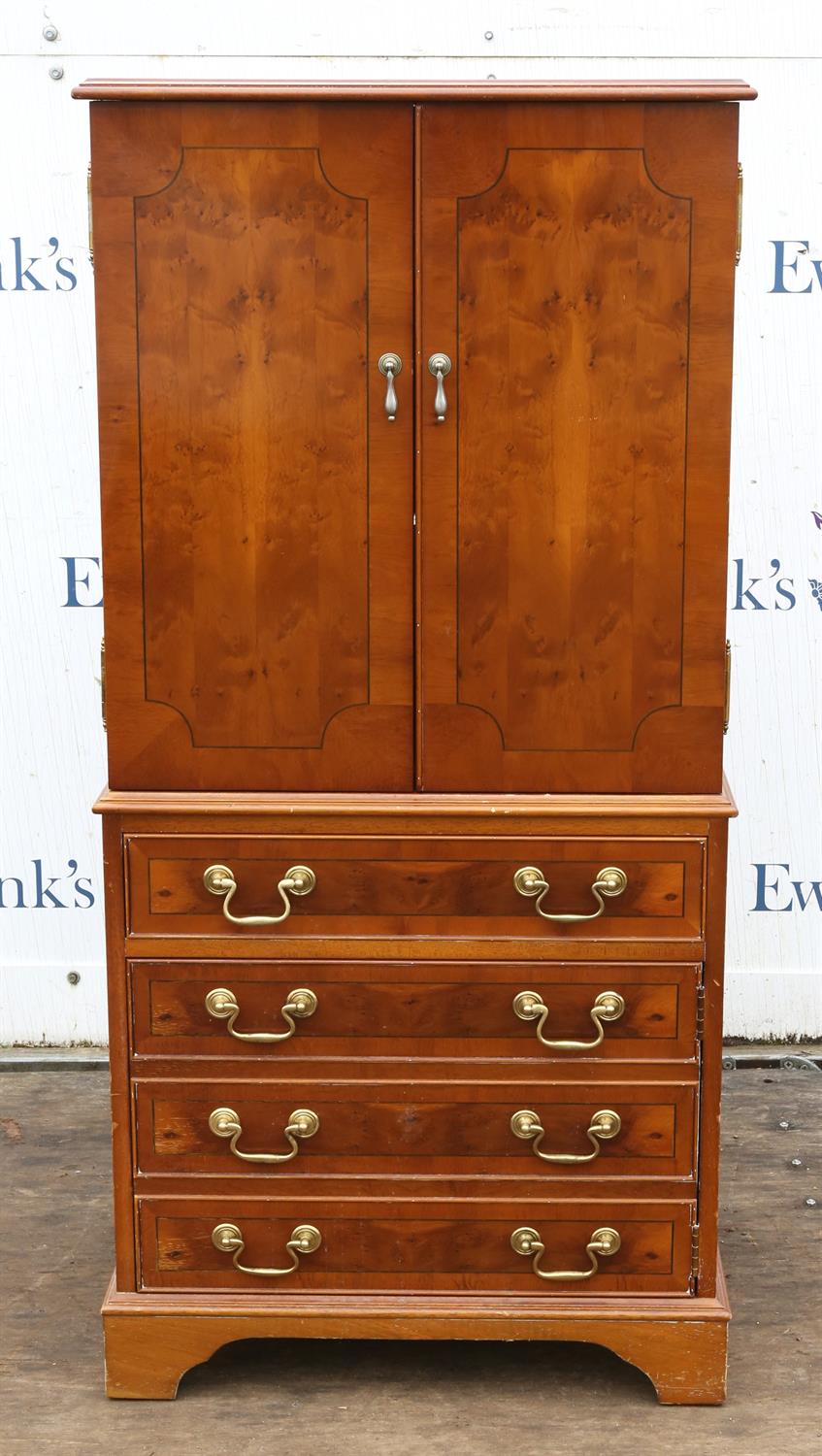 Reproduction yew wood music cabinet, with two doors enclosing shelves, above four drawers on