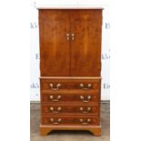 Reproduction yew wood music cabinet, with two doors enclosing shelves, above four drawers on