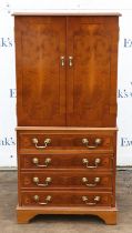 Reproduction yew wood music cabinet, with two doors enclosing shelves, above four drawers on
