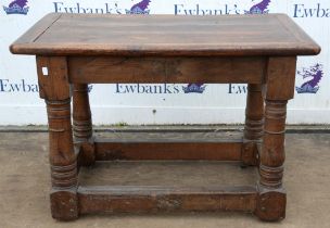 A Charles II style oak table, incorporating 17th century elements, with a cleated top and baluster
