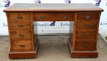 An Edwardian mahogany kneehole desk, adapted from a dressing table, with a tooled green leather